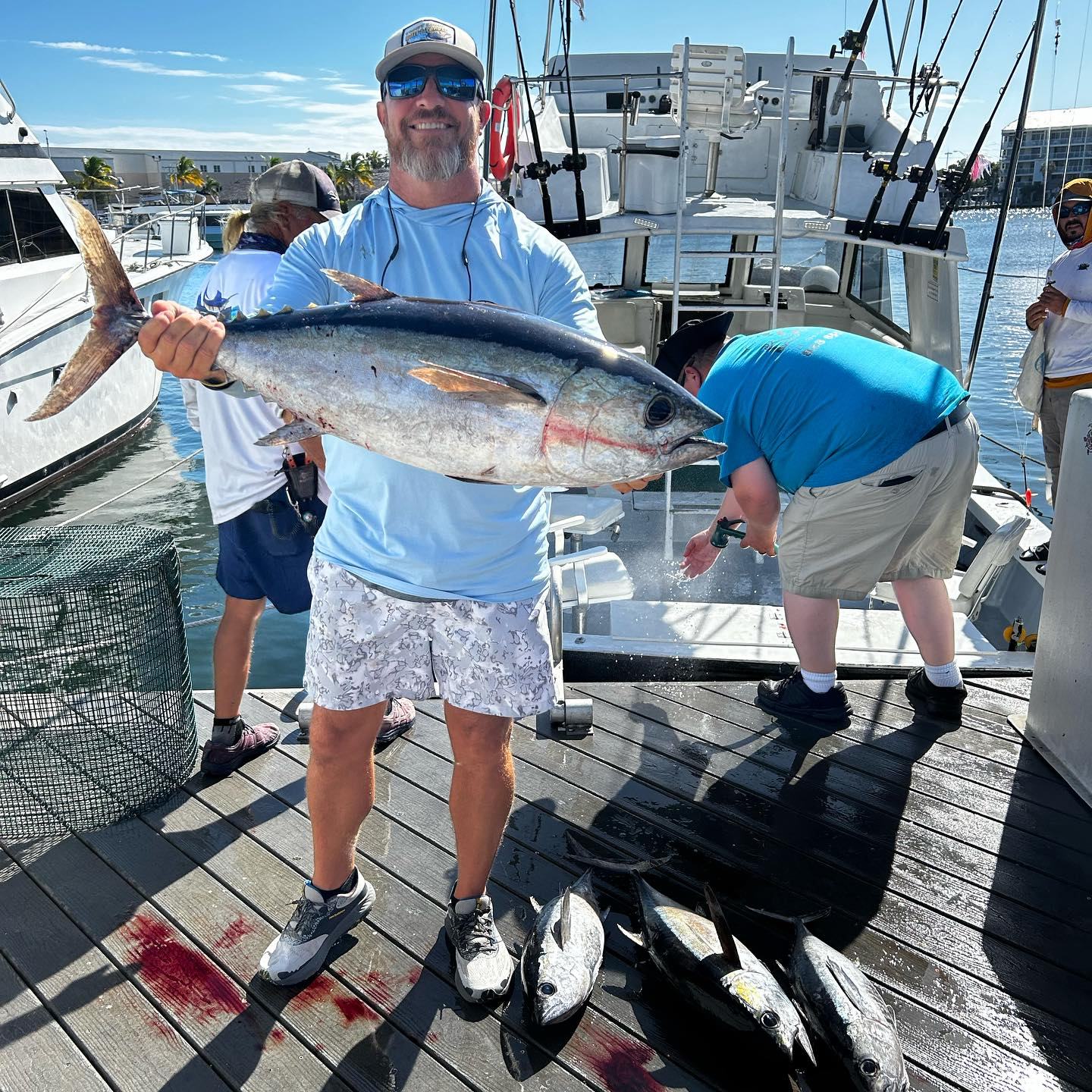Man with tuna catch at dock