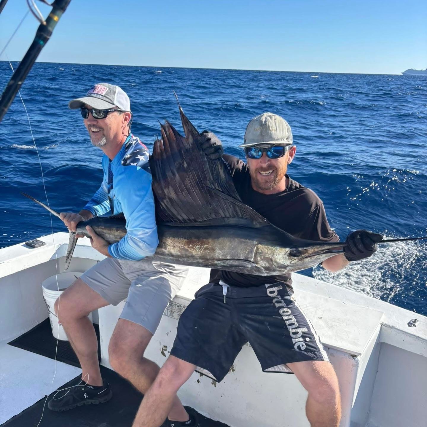 Two men with sailfish catch